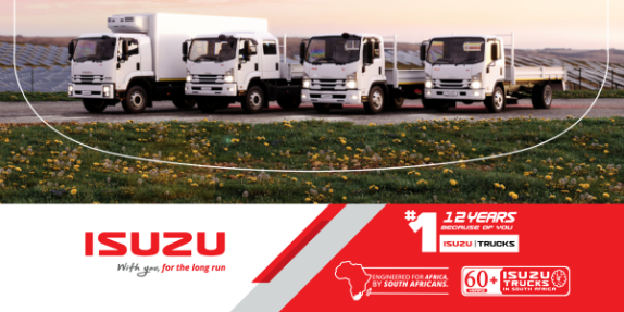 Four Isuzu trucks parked on a field.