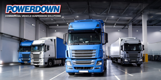 Commercial trucks with suspension solutions in warehouse.