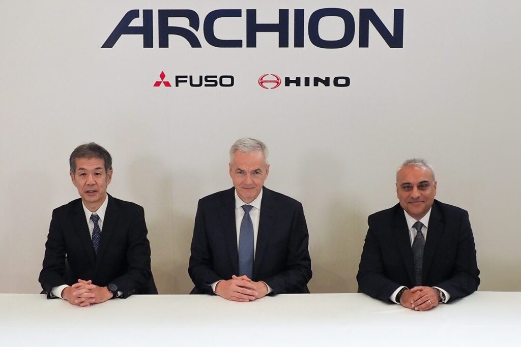 Three executives seated under Archion banner.