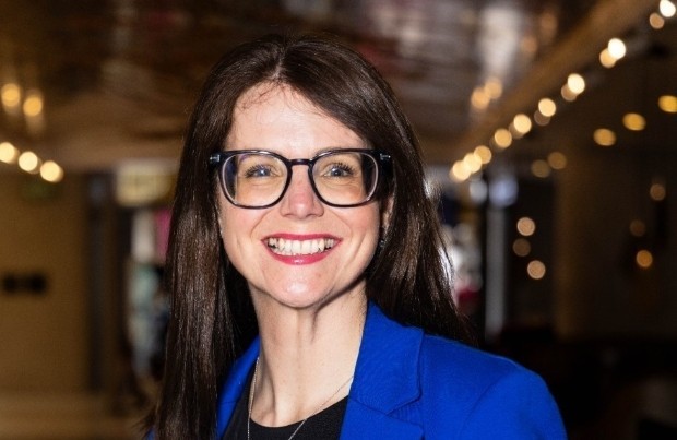 Smiling woman with glasses in blue blazer